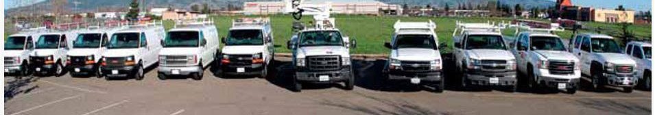 Row of white Reyff Electric service trucks