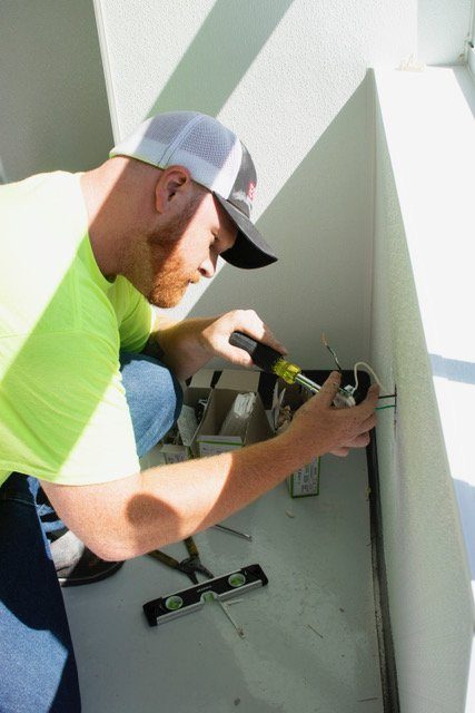 Reyff Electric technician working on an electrical box